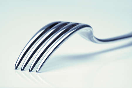 silverware - extreme closeup of a fork with blue tint の写真素材