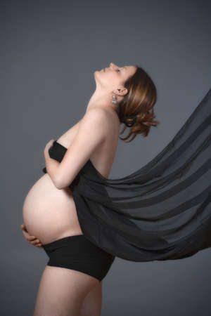 expecting woman - studio shot of a pregnant woman with cloth