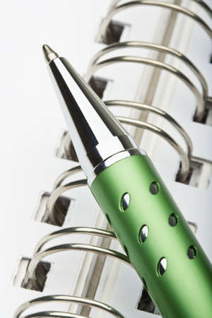 extreme closeup of a ballpoint pen and spiral notebookの写真素材