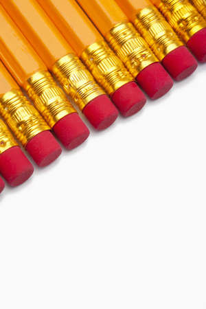 closeup of yellow pencils with red erasers isolated on whiteの写真素材