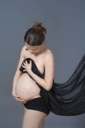 expecting woman - studio shot of a pregnant woman with clothの写真素材