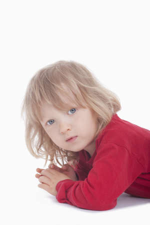 boy with long blond hair looking at camera - isolated on whiteの写真素材