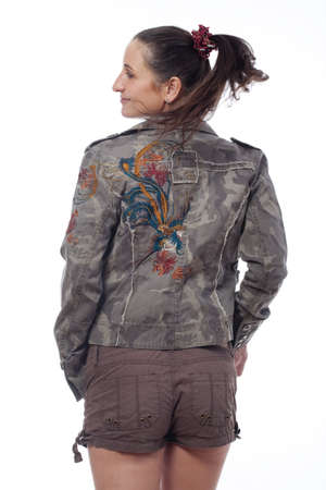 woman with brown hair in shorts and streetware jacket - isolated on white の写真素材