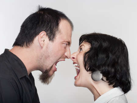 couple fighting, yelling at each other - isolated on whiteの写真素材