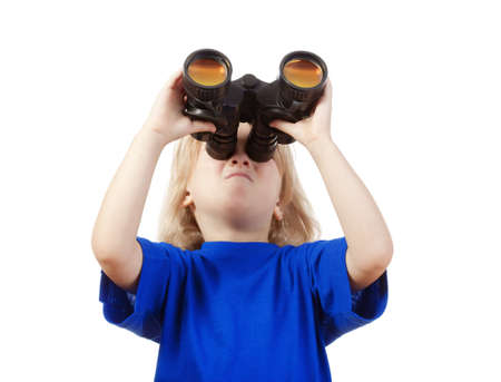 boy with long blond hair in blue top looking through binoculars - isolated on whiteの写真素材