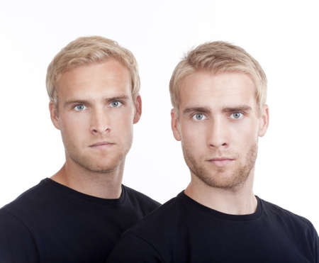 portrait of young twin brothers with blond hair and blue eyes - isolated on whiteの写真素材