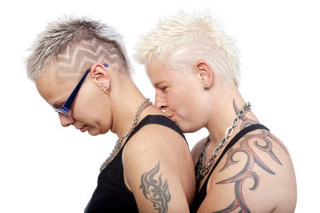 two woman with punk hairstyle kissing - isolated om whiteの写真素材