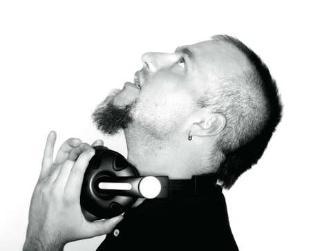 portrait of a man with beard holding headphones - isolated on white