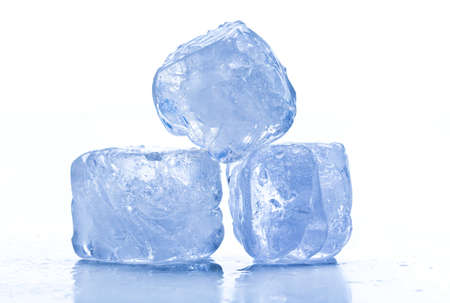 ice cubes shot on reflective white surface