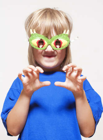 boy with funny glasses pretending to be a scary animalの写真素材