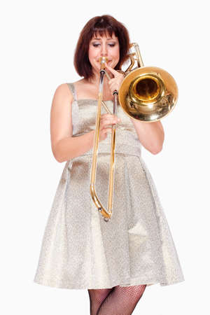 Young Female Musician Playing Trombone - Isolated on Whiteの写真素材