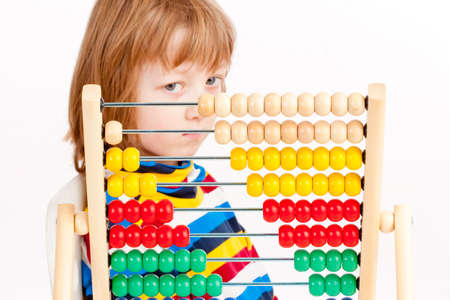 Boy Looking at Colorful Wooden Abacus Thinking - Isolated on Whiteの写真素材