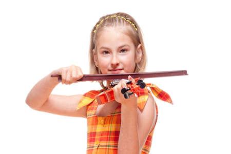 Portrait of a Little Girl Playing Toy Violin - Isolated on Whiteの写真素材