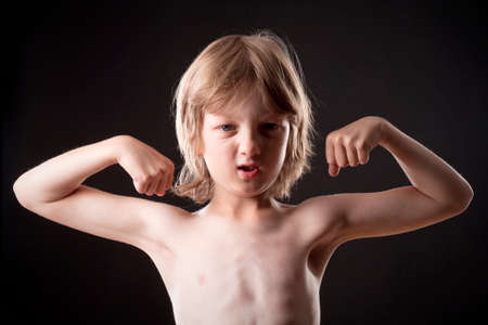 Boy with Blond Hair Showing his Musclesの写真素材