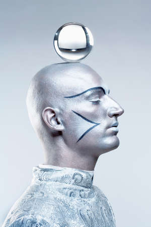 Portrait of a Magician with Glass Ball in Stage Makeup and Costumeの写真素材