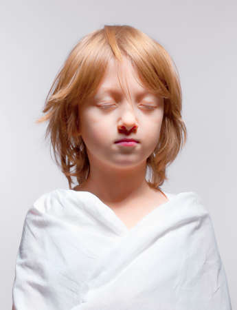 Portrait of a Boy with Closed Eyes - Isolated on Grayの写真素材