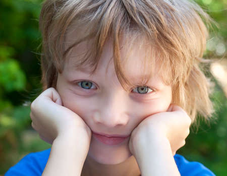 Portrait of a Boy with Blond Hair Looking Outdoors