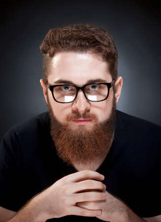 Portrait of a Teenage Hipster with Beard and Glasses