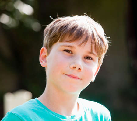 Portrait of a Boy with Brown Hair Outdoors