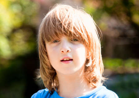 Portrait of a Boy with Blond Hair Outdoorsの写真素材