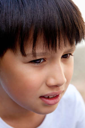 Portrait of a Boy with Dark Hair Outdoorsの写真素材
