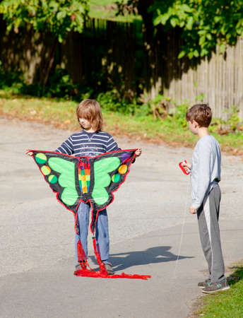 Two Boys Playing with a Kiteの写真素材