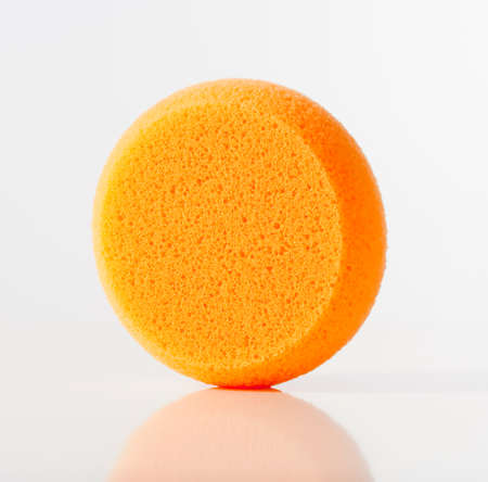 Closeup of an Orange Sponge Isolated on Whiteの写真素材