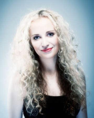 Portrait of a Young Woman with Curly Blond Hairの写真素材