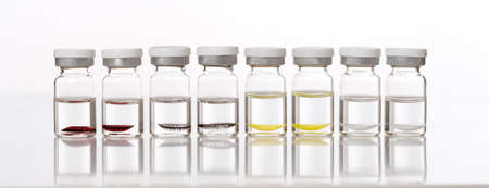 Colorful Contact Lenses in Glass Containers - Isolated on Whiteの写真素材