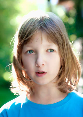 Portrait of a Boy with Blond Hair Looking Outdoorsの写真素材