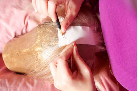 Professional Wig Maker Working in her Workshop.の写真素材