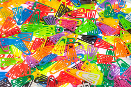 Closeup of Many Colored Paper Clips on White.の写真素材
