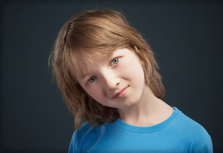 Portrait of a Boy with Long Blond Hair in Blue Top.の写真素材