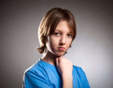 Portrait of a Boy with Blond Hair in Blue Top.