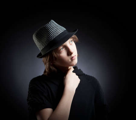 Portrait of a Boy with Blond Hair in Hat and Black Top.の写真素材