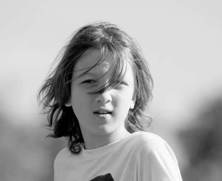 Portrait of a Boy with Brown Hair Outdoors.の写真素材