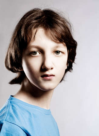 Portrait of a Teenage Boy with Brown Hair in Blue Top.の写真素材