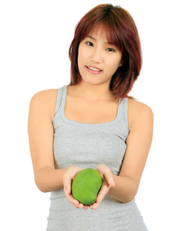 Isolated young asian woman with a mango over white.の写真素材