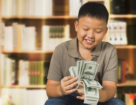 Asian boy with US dollar bank notesの写真素材