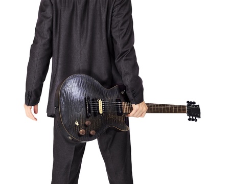 Isolated Asian man with a black electric guitarの写真素材