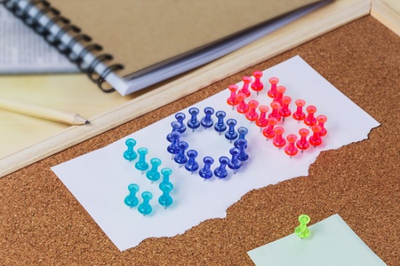 cork board with plastic pins and blank notes