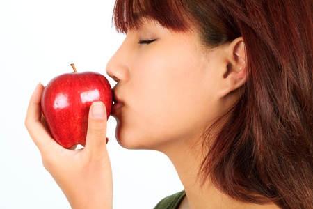 Isolated young asian woman with a red apple の写真素材