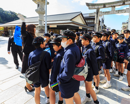 FUKUOKA, JAPAN - NOVEMBER 13: Dazaifu Tenmangu in Fukuoka, Japan on November 13, 2013. Unidentified group of Japanese students with teachers gather at a torii of Dazaifu Tenmangu to make a field trip at the shrineのeditorial素材
