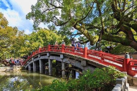 FUKUOKA, JAPAN - NOVEMBER 13: Dazaifu Tenmangu in Fukuoka, Japan on November 13, 2013. Unidentified people cross a red bridge that leads them to Dazaifu Tenmagu areaのeditorial素材