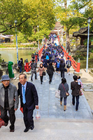 FUKUOKA, JAPAN - NOVEMBER 13: Dazaifu Tenmangu in Fukuoka, Japan on November 13, 2013. Unidentified people cross a red bridge that leads them to Dazaifu Tenmagu areaのeditorial素材