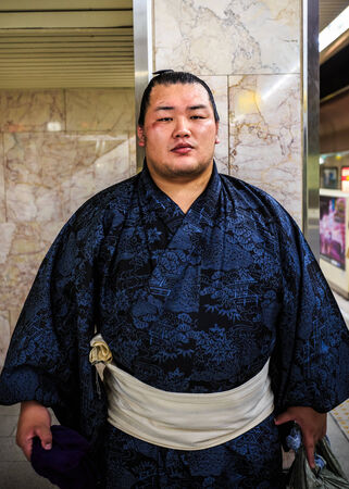 FUKUOKA, JAPAN - NOVEMBER 13: Sumo wrestler in Fukuoka, Japan on November 13, 2013. Unidentified Japanese Sumo wrestler waits for a train to his tournament at Fukuoka Sumo arenaのeditorial素材