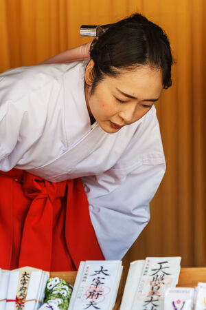FUKUOKA, JAPAN - NOVEMBER 13: Shrine maiden in Fukuoka, Japan on November 13, 2013. "Miko" is  an institutionalized in daily shrine life. Trained to perform task ranging from sacred cleansing to performing a sacred danceのeditorial素材