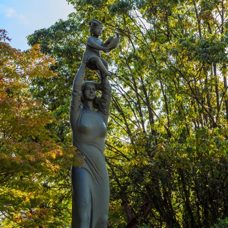NAGASAKI, JAPAN - NOVEMBER 14: Nagasaki Peace Park in Nagasaki, Japan on November 14, 2013. Hymn to life Sculpture in Peace Symbols Zone, a mother holds a baby high in the air in expression of love and peaceのeditorial素材