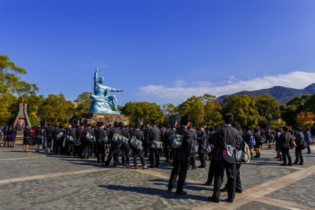 NAGASAKI, JAPAN - NOVEMBER 14: Nagasaki Peace Park in Nagasaki, Japan on November 14, 2013. Unidentified group of students visit Nagasaki Peace Monument at Nagasaki Peace Parkのeditorial素材