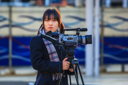 NARA, JAPAN - NOVEMBER 16  Japanese Students in Nara, Japan on November 16, 2013   Unidentified Japanese students with camera have a workshop of interviewing people at Nara Stationのeditorial素材